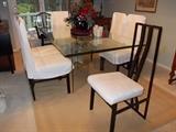 Modern glass table with wrought iron chairs