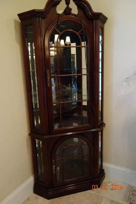 Curio cabinet - lighted with glass shelves.  Curved top glass doors