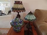 Assorted Tiffany style lamps.