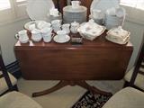 83 piece Cotillion china. Drop leaf table with 4 leaves.