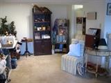 Bookcase, side chair, half table, christmas items, wall hangings.