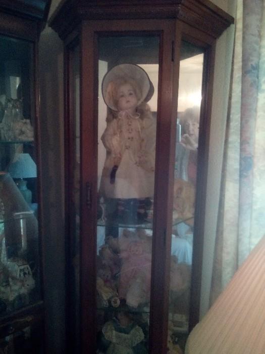 Tall, Slender Curio Cabinet (this is the top half).  Dolls - some in the original boxes - including Cabbage Patch.
