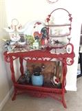 Red wicker sofa/entry table. Really cute roosters and vintage kitchen utensils.