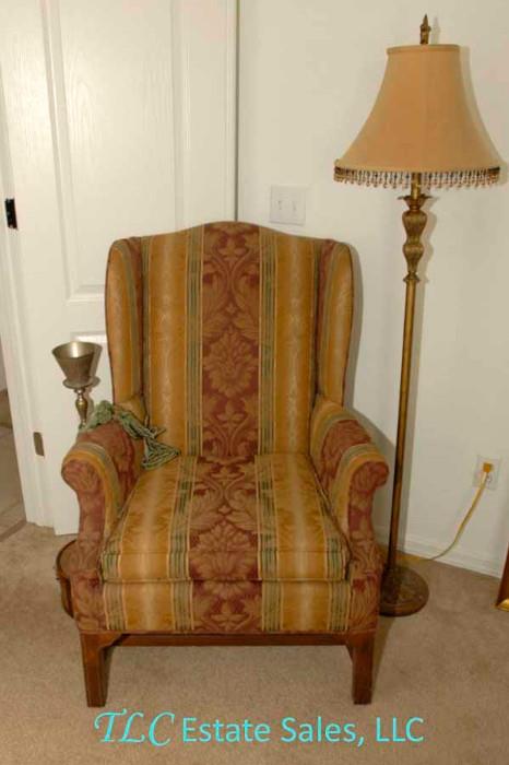 Upholstered chair with lamp.