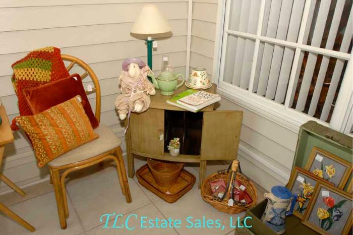 Small end table, chair, baskets and framed art.
