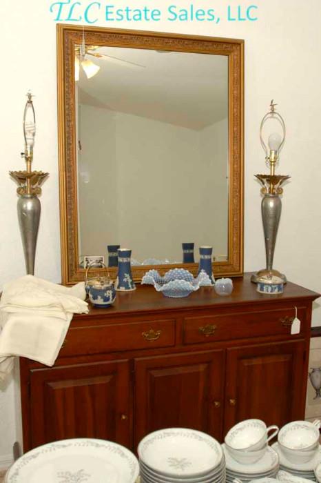 Beautiful dresser with mirror, lamps and glassware.