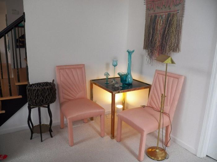 Pink upholstered chairs, corner table, lamp and side table