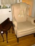 Upholstered wing chair and chair side mahogany book rack