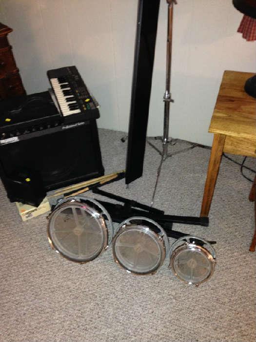 Drums, cymbal stand, amplifier, small keyboard