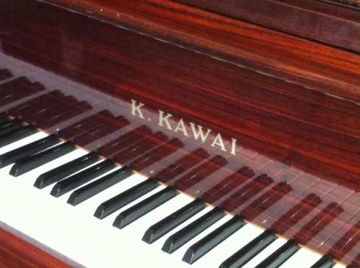 Kawai KG-2C studio grand piano with matching bench.