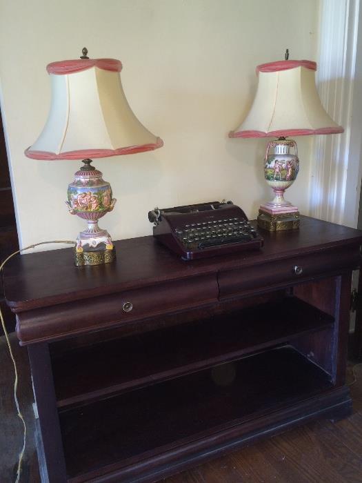 Versatile furniture piece with 2 drawers and shelves, vintage lamps and antique Corona typewriter.