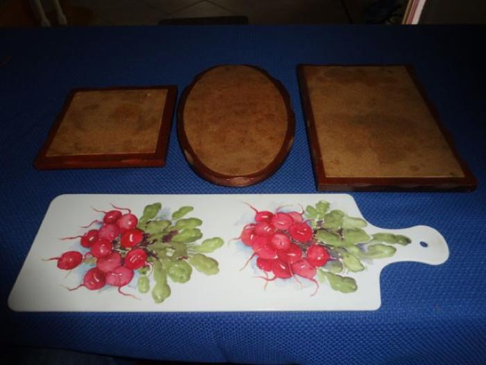 Various cutting boards, one has turnips painted on it.