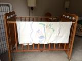 Crib is complete with working raise/lower sides, mattress spring and mattress