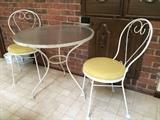 Wrought-iron ice-cream soda table and chairs; yellow vinyl cushions with no rips