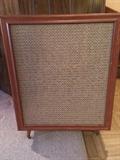 This vintage speaker with tapered mid-century legs no longer contains its innards so could be a delightful side table
