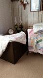 Quilts, trunk, clock and oil lamps