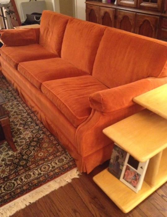 Vintage Orange Couch flanked by two  Mid Century Modern Side Tables