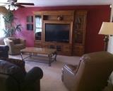 Stone Creek custom-make media center. 57" Mitsubishi 2007 flat-screen HDTV. La-Z-Boy concrete & wrought iron coffee table (matching sofa & end tables not pictured here). La-Z-Boy swivel tub chair. 