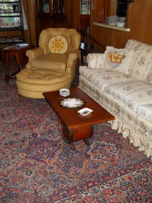 coffee table made with vintage butter churn, o/s chair & ottoman, Karastan rug, etc.