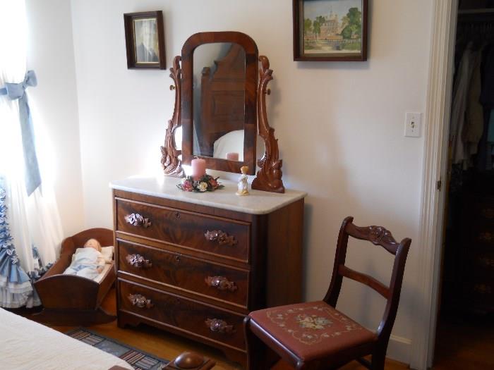 wooden cradle, life like doll, vintage marble top dresser w/mirror, roseback chair w/needlepoint seat, etc.