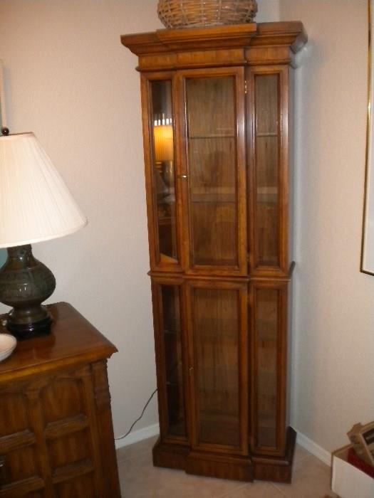 Wood curio cabinet with glass shelves.