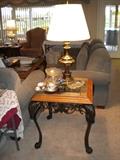Wrought iron and wood side table with glass top and inlaid tile/stone edges.