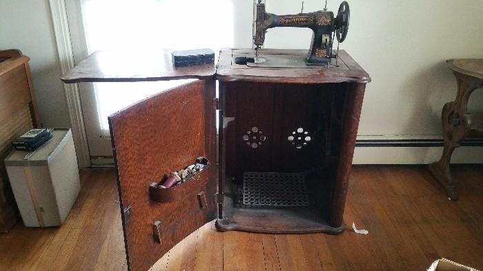 Antique 'White Rotary' sewing machine.  Serial # FR 2324732 with original accessory tin full of attachments.                              