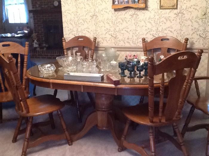 dining room table with with a glass top and six chairs