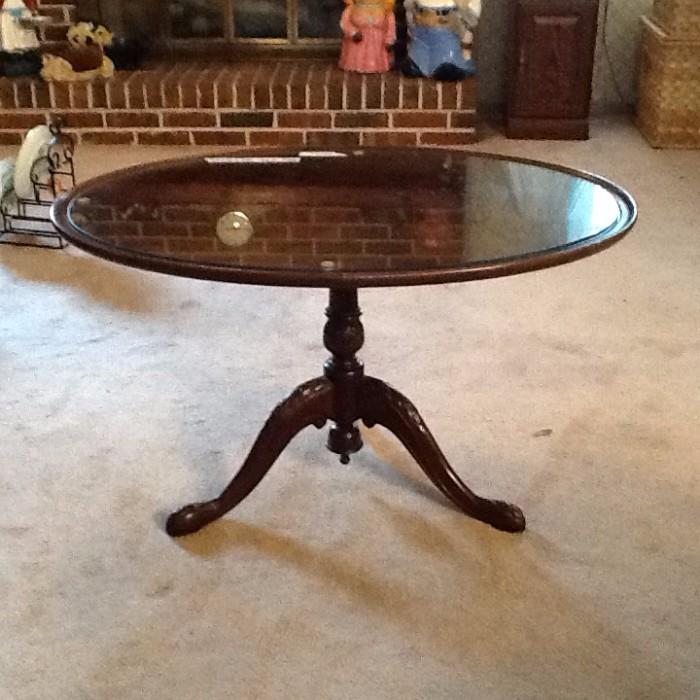 solid mahogany tilt table with carved pedastal, glass top
