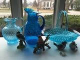 My fave is that Blue Crackle Glass hand-blown pitcher in the center.  We have Tiara on the left and I believe it's blue American Fostoria on the right.