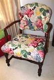 Vintage Arm Chair with nicely carved scrolled arms, and turned legs and supports.  Chair has vibrant rose and blue colored floral pattern upholstery