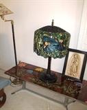 Art Deco Style Tile and Metal Coffee Table with floral accented tile top and metal base; Reproduction Tiffany Style Lamp with bird design shade and metal base; Accent Floor Lamp with brass & metal base and floral pattern shade; The religious theme artwork is also available