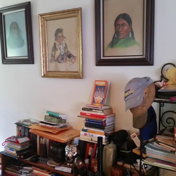 books; book shelf; framed Native American paintings