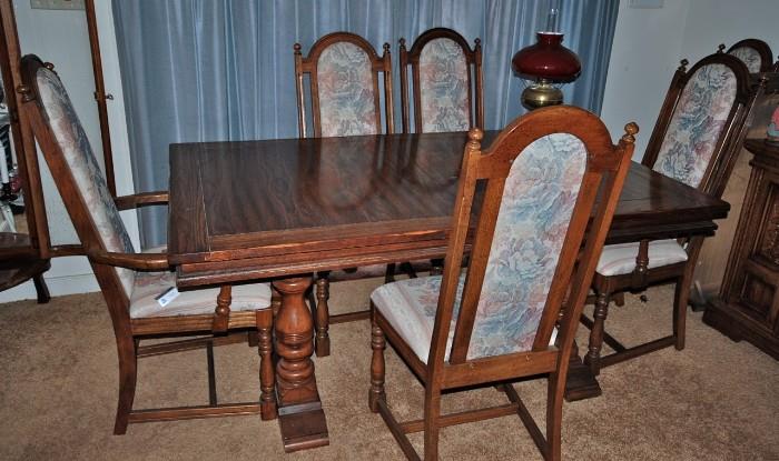 Table with one extension, two armchairs, and four side chairs. There is also a large matching China Cabinet.
