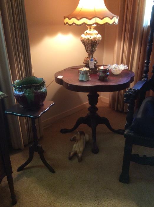 Scalloped leather top table, candle stand, majolica planter.