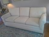 Fine, off-white couch with light wear.