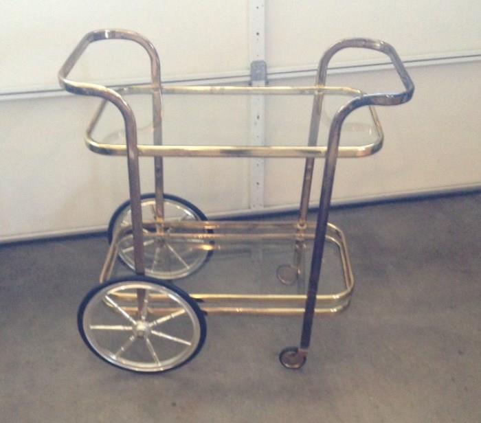 Brass finish mobile cart, glass shelves, excellent condition.