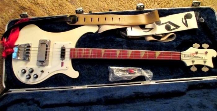 New-unused Rickenbacker electric guitar in original case with two big Elvis style shoulder straps