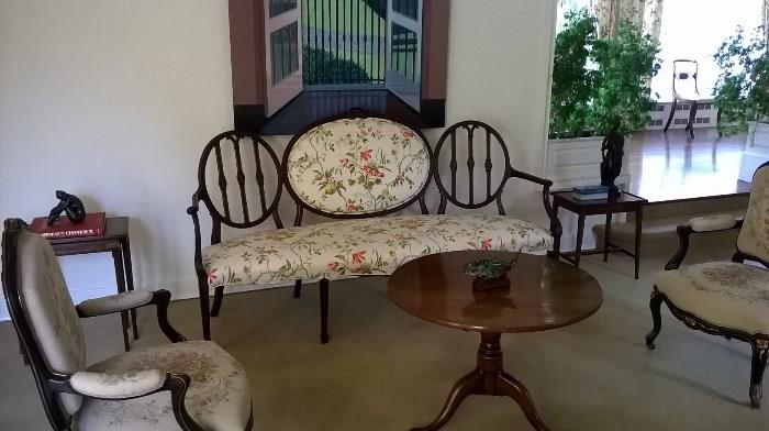 Antique sofa upholstered and gorgeous wooden frame.  Tables and armchairs also for sale, art is not