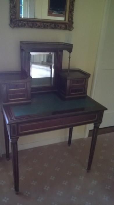 Desk or vanity with leather inlay on the surface and a mirror for primping!  31.5"w x 19"d x 28"h to the writing surface