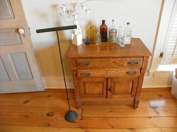 antique bottles, commode, cast iron display stand