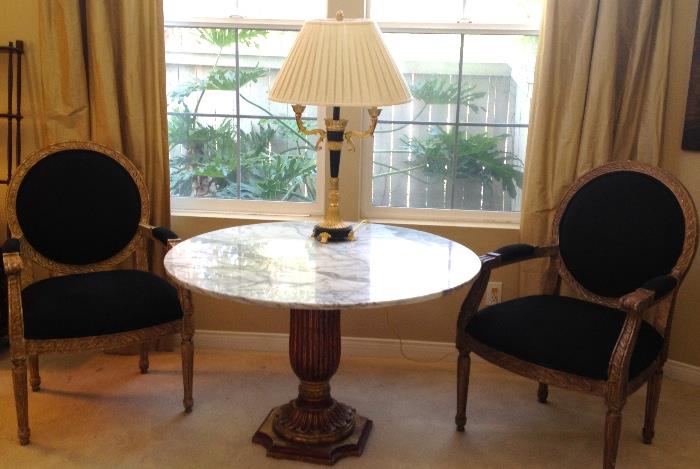 Vintage round marble table and Neoclassical black chairs