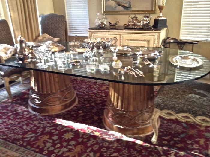 9 foot glass top dining able with 2 wood carved pedestals.  