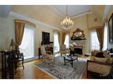 Oriental rug, framed portrait and mirror above fireplace are not for sale...
