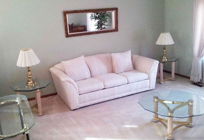 Beautiful clean white couch with matching chairs. Brass and glass coffee and end tables