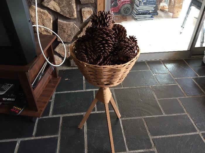 TV w stand, basket of pine cones
