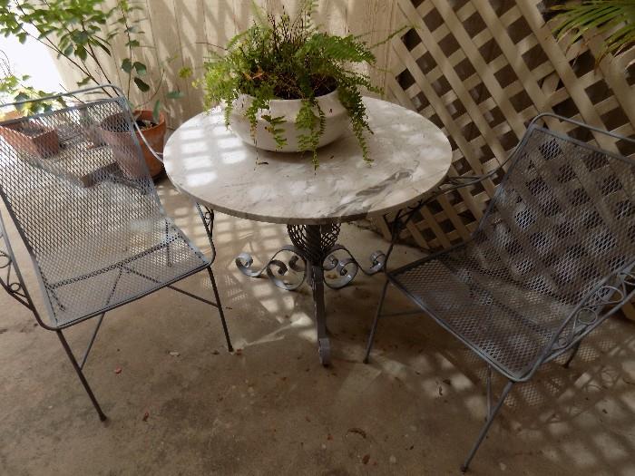Wrought iron patio table with 2 chairs...very Austintatious made with marble from the Littlefield building in downtown Austin!