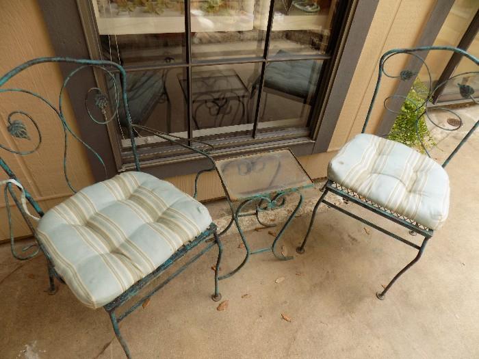 wrought iron chairs and accent table