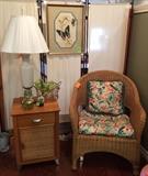 Cute rattan chair, nightstand, lamp and art.