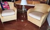Pair of natural woven rattan chairs with ivory cushions from Pier One.